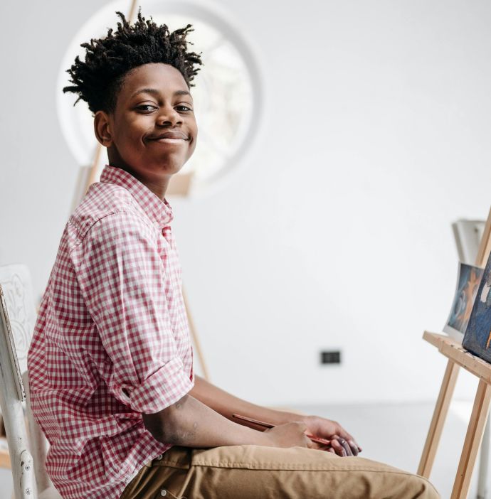 Young students enjoying a painting class, engaged and creative in an art room.